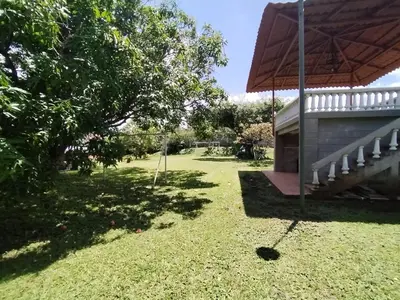 a yard with a porch and a swing at blanc haus in Grecia
