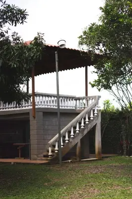 a porch with a deck on top of a building at blanc haus in Grecia