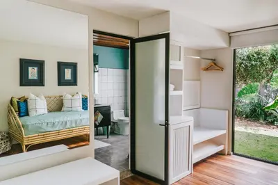 a room with a bathroom with a bed and a glass door at Casa 41 in Escazu