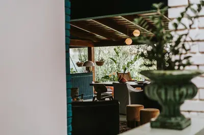 a room with a table and chairs and a vase at Casa 41 in Escazu
