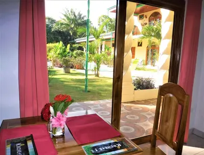 a table with a mirror and a table with flowers on it at COCO Beach Village in Matapalo