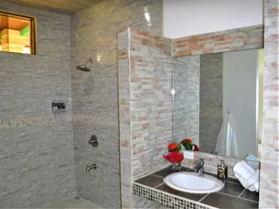 a bathroom with a sink and a shower at COCO Beach Village in Matapalo