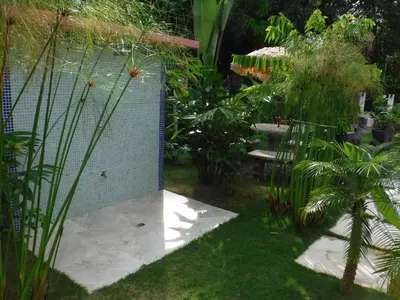 a garden with a fence and some plants at COCO Beach Village in Matapalo
