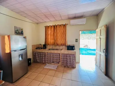 a kitchen with a stainless steel refrigerator and a window at Los Sueños RyG 1 in Quepos