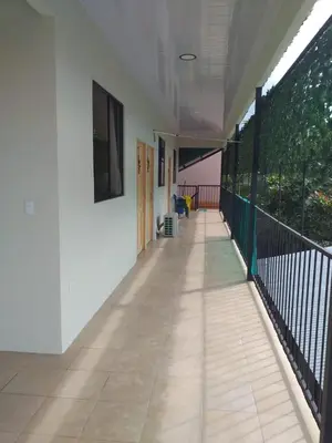 an empty hallway of a building with a balcony at Los Sueños RyG 1 in Quepos