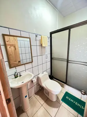 a small bathroom with a toilet and a sink at Los Sueños RyG 1 in Quepos