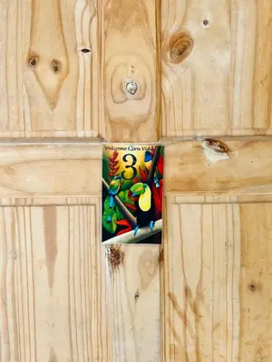 a book on a wooden door with a painting on it at Los Sueños RyG 1 in Quepos