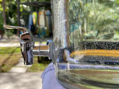 a close up of a glass cup with a faucet at Ride On! Surf Hotel in Nosara