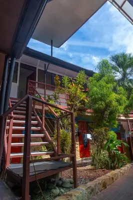 a wooden staircase leading up to a house at Costa Linda Art Hostel in Manuel Antonio