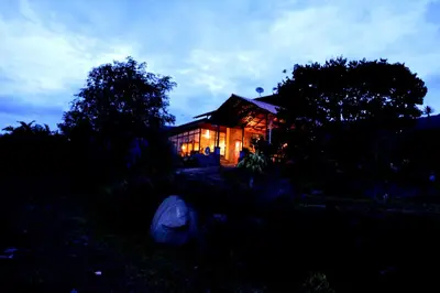 a house at night with its lights on at Guayabo Lodge in Santa Cruz