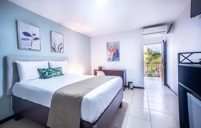 a bedroom with a large bed in a room at Paradise Jaco Beach Front in Jacó