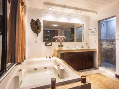 a large bathroom with a tub and a sink at Paradise Jaco Beach Front in Jacó