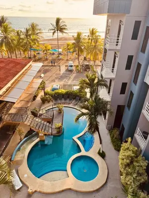 an aerial view of a resort with a swimming pool and the beach at Paradise Jaco Beach Front in Jacó