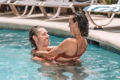 a man and a woman in a swimming pool at Paradise Jaco Beach Front in Jacó