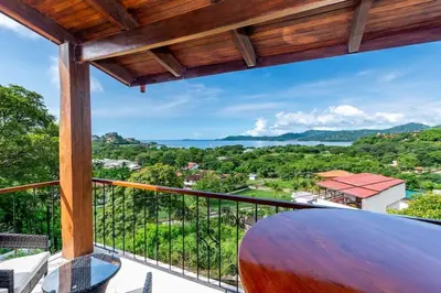 a balcony with a view of the ocean at Ocean-View 2-BD Condo with Pool in Playa Flamingo