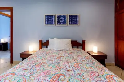 a bedroom with a large bed with two night stands at Ocean-View 2-BD Condo with Pool in Playa Flamingo