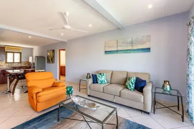 a living room with a couch and a table at Ocean-View 2-BD Condo with Pool in Playa Flamingo