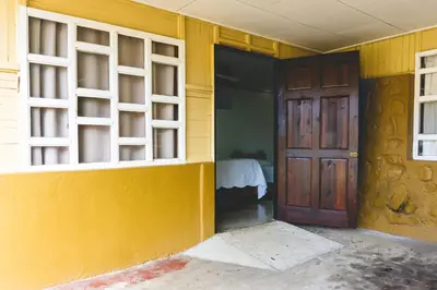 an empty room with a door and a yellow wall at Cabinas EL PRADO in San Isidro