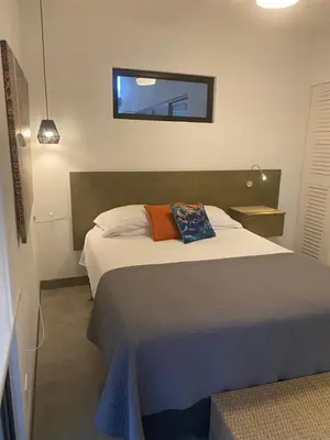 a bedroom with a bed and a window on the wall at Bungle in the Jungle in Playa Panama