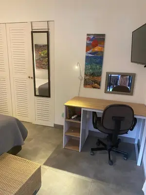 a desk in a room with a chair and a mirror at Bungle in the Jungle in Playa Panama