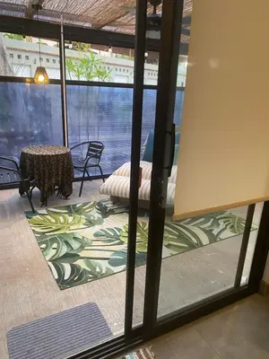 a room with a glass door with a table and chairs at Bungle in the Jungle in Playa Panama