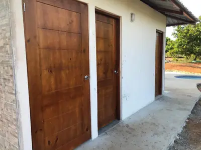 two wooden doors on the side of a building at Quinta Don Noé in San Mateo