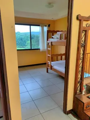 a room with a bedroom with a bunk bed and a window at Quinta Don Noé in San Mateo