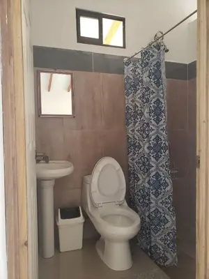 a bathroom with a toilet and a sink at Cabinas ensueños in Tortuguero