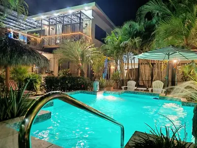 a swimming pool in front of a building at Suite Paraiso Azul in Tamarindo