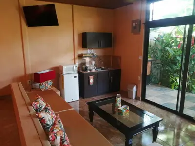 a living room with a couch and a table at Suite Paraiso Azul in Tamarindo
