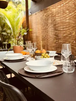 a table with plates and bowls of fruit on it at Hotel Daleese in Uvita