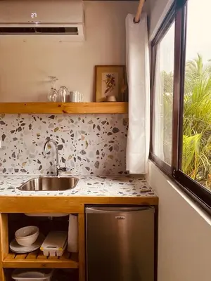 a kitchen with a sink and a window at Hotel Daleese in Uvita