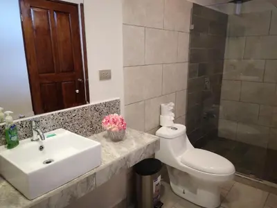 a bathroom with a sink and a toilet at Hotel Amira in Carrillo