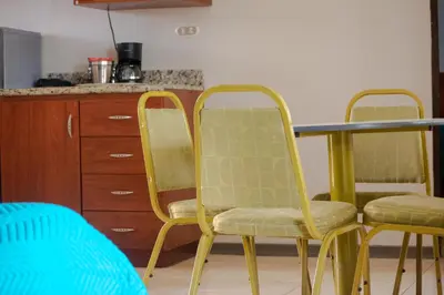 two chairs and a table in a kitchen at Hotel y Restaurante El Guarco in Cartago