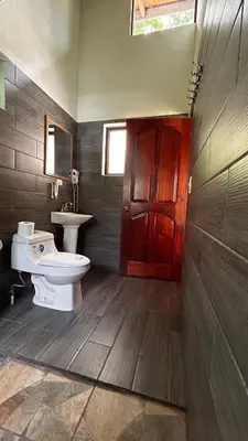 a bathroom with a toilet and a sink at Coffee House in Monteverde Costa Rica