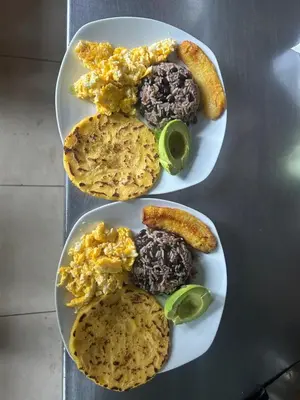 two plates of food on a table with breakfast foods at Coffee House in Monteverde Costa Rica