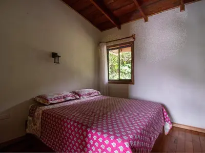 a bedroom with a bed and a window at Coffee House in Monteverde Costa Rica