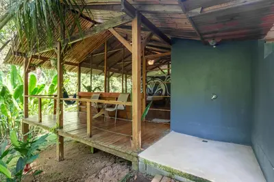 a pavilion with a table and chairs in a room at Private jungle “Loft del Rio” river access in Uvita