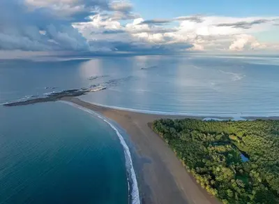 an aerial view of a beach and the ocean at Private jungle “Loft del Rio” river access in Uvita