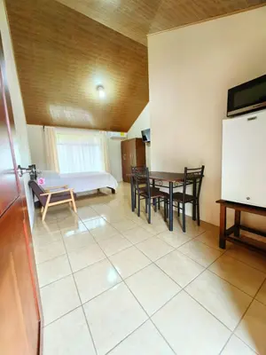 a room with a table and chairs and a bed at Habitaciones el corral in Aguacate