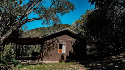 a small building with a hill on top of it at Granja los Campesinos in Monteverde Costa Rica