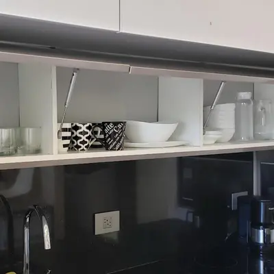 a kitchen shelf with bowls and plates on it at Cozy private Apartment, Mirador Escazú -Great view- in Escazu