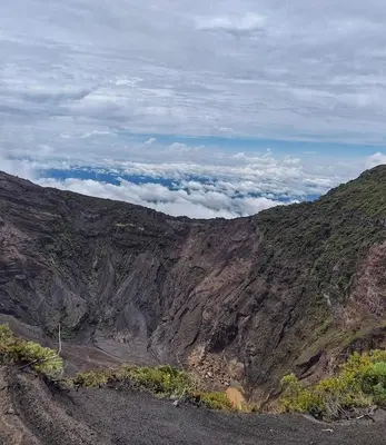 a view of a mountain with clouds in the background at Casa Chicua in Sabanilla