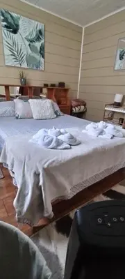 a bedroom with two beds with towels on it at Casa Chicua in Sabanilla