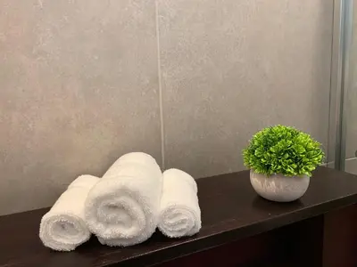 a bunch of rolled towels on a counter in a bathroom at ARANJUEZ LOFTS Santa Ana in Santa Ana