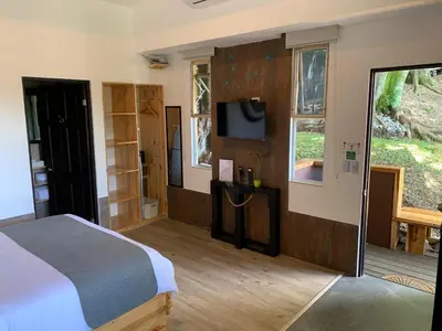 a bedroom with a bed and a flat screen tv at ARANJUEZ LOFTS Santa Ana in Santa Ana