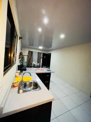 a kitchen with a sink and a counter top at Around Juan Santa María in Alajuela City