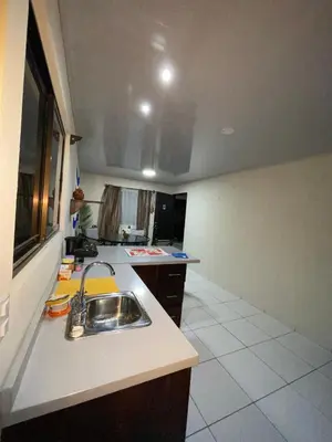 a kitchen with a sink and a counter top at Around Juan Santa María in Alajuela City