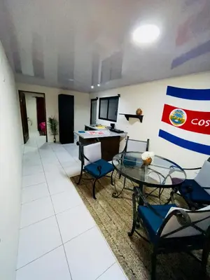 a room with a table and chairs and a desk at Around Juan Santa María in Alajuela City
