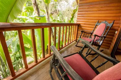 two rocking chairs sitting on a porch at Arenal Rústic Lodge in Fortuna